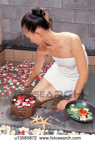 Stock Image - beauty spa female, quarter length, bathrobe, bowl, wrapped in towel, health. Fotosearch