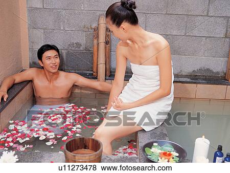 Stock Photo - candle, beauty spa female, beautifying, relation, rose petals, carefree, toothy smile. Fotosearch