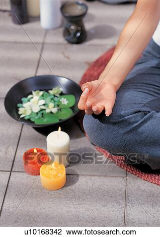 Stock Image - exercising, candles, outdoor, beauty treatment, mat, meditating. Fotosearch