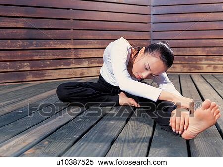 Stock Photography - flexibility, woman, carefree, indoor, young adult, asian ethnicity. Fotosearch