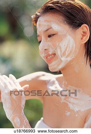Stock Image - glancing, freshening, close-up, outdoor, one person, head and shoulders. Fotosearch