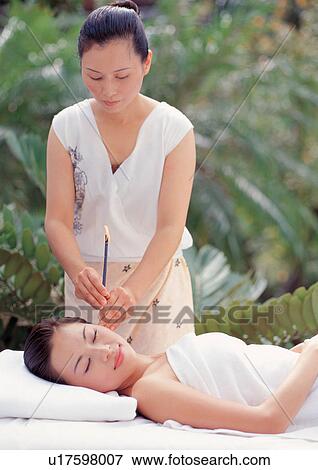 Stock Photo - health spa, massage therapist, black hair, day, care, two people, closed eyes. Fotosearch