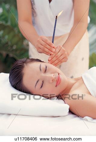 Stock Photograph - Spa ear candling . Fotosearch