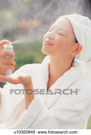 Stock Photo - Spa woman spaying her face. Fotosearch