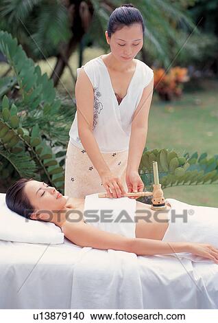 Stock Image - special, health spa, asian ethnicity, female, closed eyes, grass, heating. Fotosearch