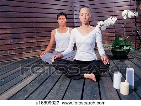 Stock Photo - Two people in the lotus position. Fotosearch