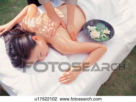 Stock Image - two people, leisure, carefree, human hands, asian ethnicity, grass. Fotosearch