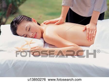 Woman getting a massage View Large Photo Image Stock Photograph - Woman getting a massage . Fotosearch