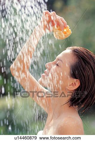 Stock Photo - Woman taking an outdoor shower . Fotosearch