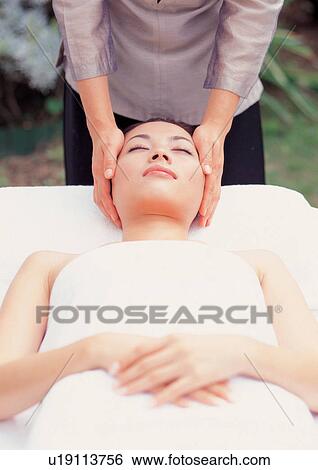 Young Asian woman receiving facial massage View Large Photo Image Stock Photograph - Young Asian woman receiving facial massage. Fotosearch