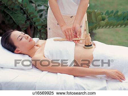 Stock Photography - Young Asian woman receiving spa treatment. Fotosearch