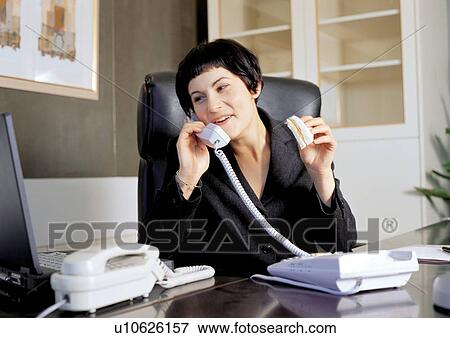 Stock Photo - business people, connectivity, woman only, talking, communication, business woman, sitting. Fotosearch