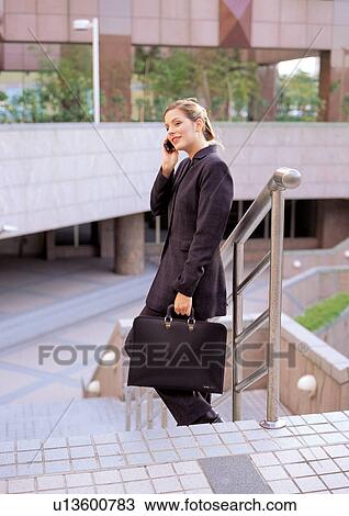 Stock Image - business people, well dressed, on the phone, connectivity. Fotosearch