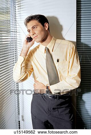 Stock Image - business people, well dressed, on the phone, connectivity. Fotosearch