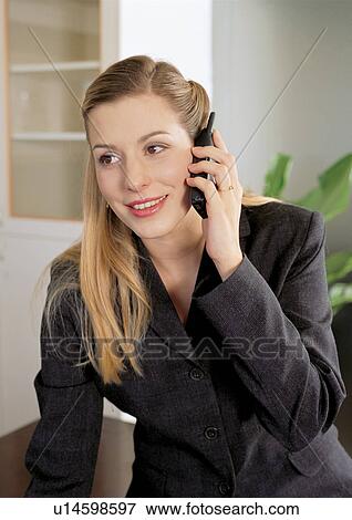 Stock Photo - business people, well dressed, on the phone, connectivity. Fotosearch