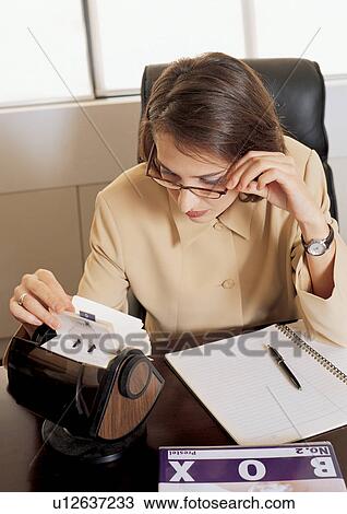 business woman, files, looking down, lifestyle, indoor, culture View Large Photo Image Stock Image - business woman, files, looking down, lifestyle, indoor, culture. Fotosearch