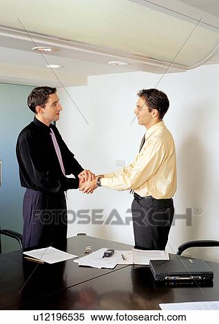 Stock Photography - indoor, happiness, technology, hands clasped, office papers. Fotosearch