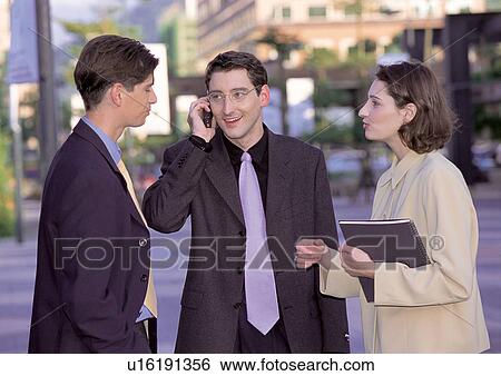 Stock Photograph - three people, communication, business executives, career, connectivity, friendship. Fotosearch