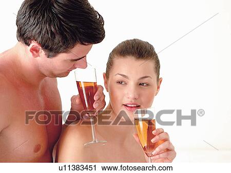 Stock Image - couples, lying down, indoor. Fotosearch
