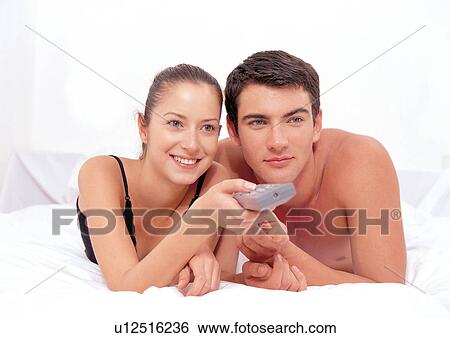 Stock Photograph - couples, lying down, indoor. Fotosearch