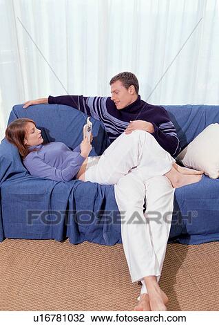 Stock Image - couples, lying down, sitting, indoor. Fotosearch