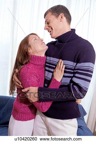 Stock Image - couples, standing, indoor. Fotosearch