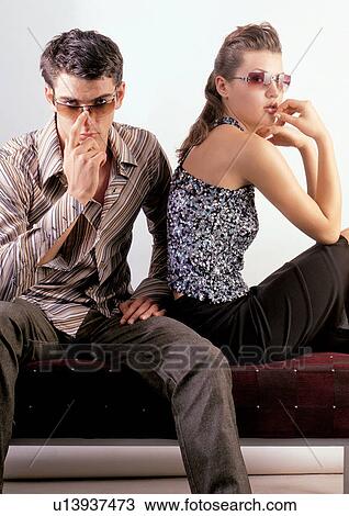 Stock Image - indoor, love, romance, adjusting, young man. Fotosearch