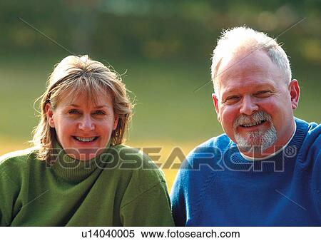 Stock Photography - Middle aged couple in a park. Fotosearch