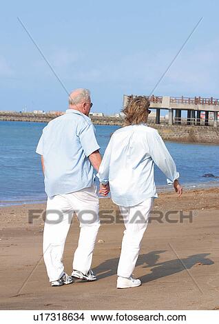 Picture - side by side, rear view, senior woman, senior couple. Fotosearch