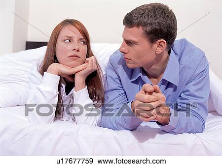 Stock Photo - side by side, togetherness, casual clothing, bed, lifestyle, affection. Fotosearch