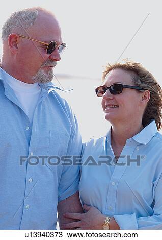 Stock Image - sunlight, looking at each other, couples, standing, love, emotion. Fotosearch