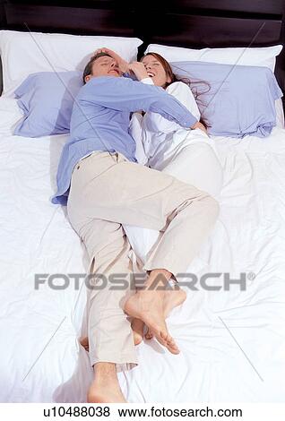 togetherness, lying down, carefree, romance, embracing, mid adult man View Large Photo Image Stock Photo - togetherness, lying down, carefree, romance, embracing, mid adult man. Fotosearch