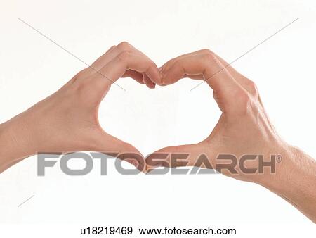 Stock Photo - Close-up of a couple's hands making a heart shape. Fotosearch