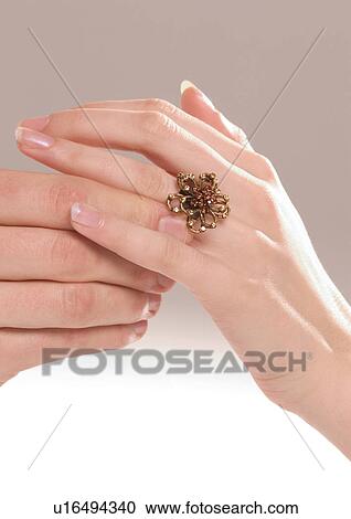 Close-up of a man's hand putting a ring on a woman's finger View Large Photo Image Stock Image - Close-up of a man's hand putting a ring on a woman's finger. Fotosearch