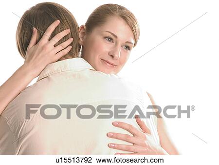 Stock Image - Close-up of a young couple hugging. Fotosearch