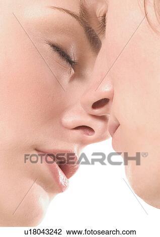 Stock Image - Close-up of a young couple kissing. Fotosearch