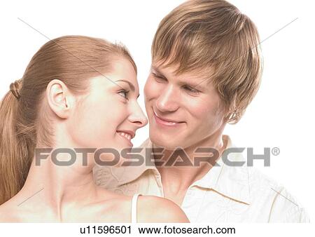 Close-up of a young couple looking at each other View Large Photo Image Stock Image - Close-up of a young couple looking at each other. Fotosearch
