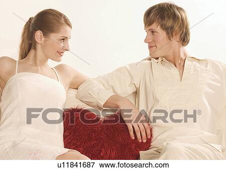 Close-up of a young couple looking at each other View Large Photo Image Stock Photo - Close-up of a young couple looking at each other. Fotosearch