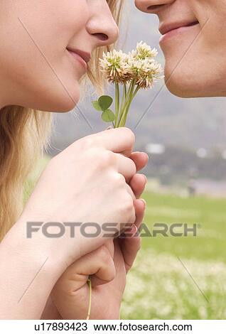 Close-up of a young couple smiling at each other View Large Photo Image Stock Image - Close-up of a young couple smiling at each other. Fotosearch