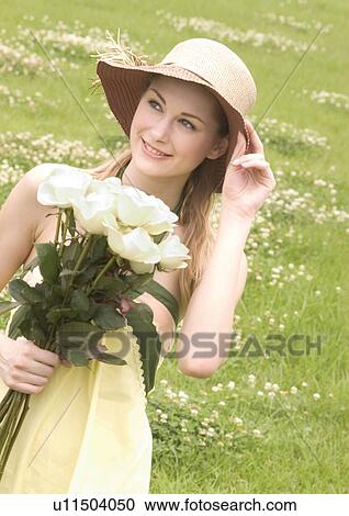 Close-up of a young woman holding a bouquet of white roses View Large Photo Image Stock Image - Close-up of a young woman holding a bouquet of white roses. Fotosearch