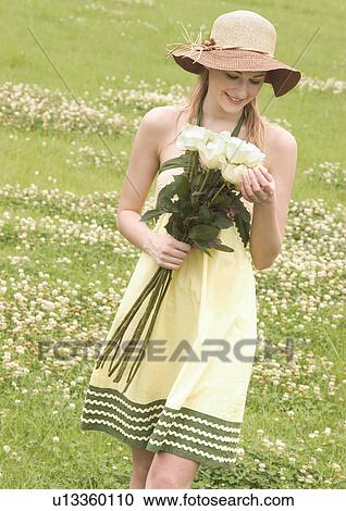 Close-up of a young woman holding a bouquet of white roses View Large Photo Image Stock Image - Close-up of a young woman holding a bouquet of white roses. Fotosearch