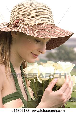 Stock Photo - Close-up of a young woman holding a bouquet of white roses. Fotosearch
