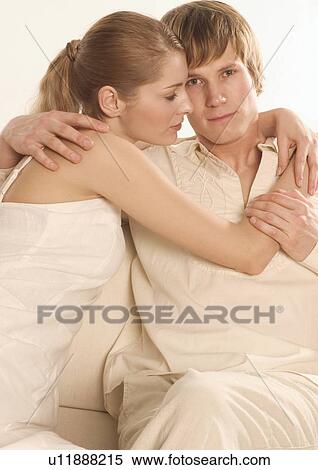 Close-up of a young woman hugging a young man View Large Photo Image Stock Photography - Close-up of a young woman hugging a young man. Fotosearch