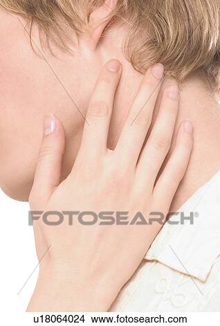 Picture - Close-up of a young woman's hand on a young man's neck. Fotosearch