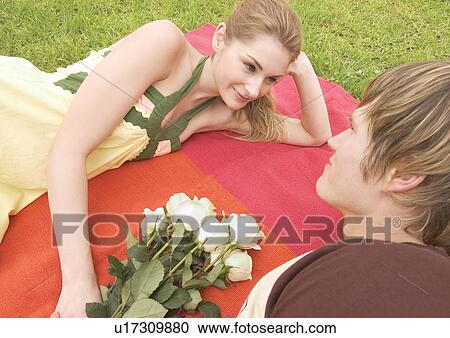High angle view of a young couple lying face to face View Large Photo Image Stock Image - High angle view of a young couple lying face to face. Fotosearch