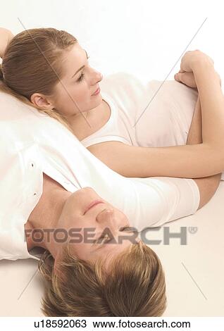 Stock Image - High angle view of a young couple sleeping. Fotosearch