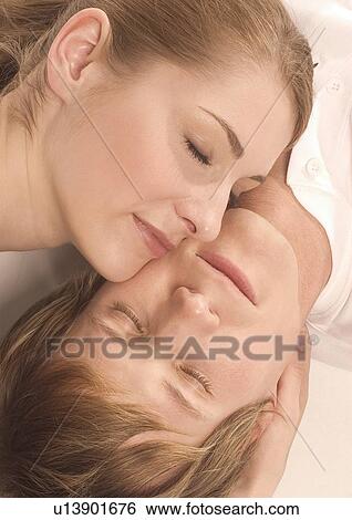 Stock Photograph - High angle view of a young couple sleeping. Fotosearch