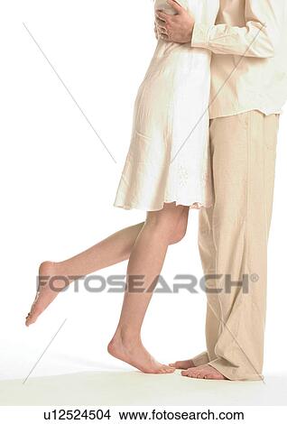 Low section view of a young couple hugging View Large Photo Image Picture - Low section view of a young couple hugging. Fotosearch
