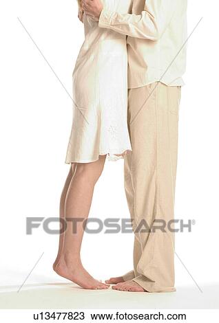 Low section view of a young couple hugging View Large Photo Image Stock Image - Low section view of a young couple hugging. Fotosearch