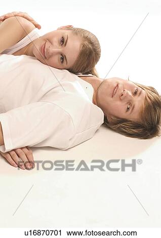 Stock Image - Portrait of a young woman lying on a young man's chest. Fotosearch